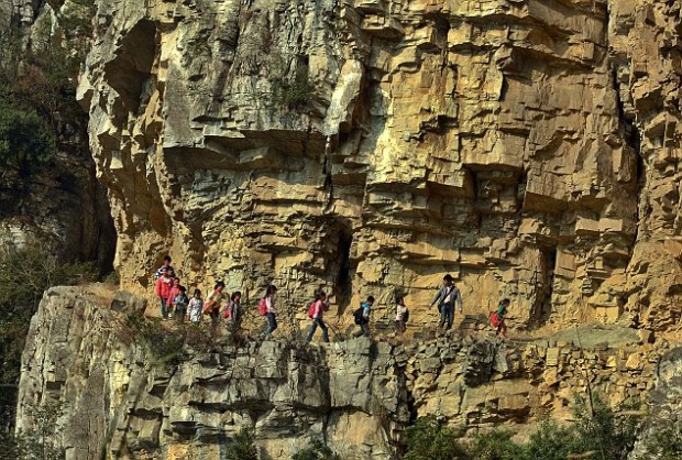 Children navigate dangerous mountain footpath to get to school, Bijie, Guizhou Province, China - 11 Mar 2013