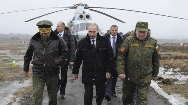 Russia's President Putin, accompanied by Russian Defence Minister Shoigu, walks to watch military exercises upon his arrival at Kirillovsky firing ground in Leningrad region