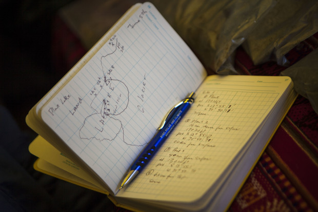 This June 6, 2015 photo, shows Dr. Lonnie Thompson's notebook with notes and drawing about plants found near a lake on the Quelccaya Ice Cap in Peru . Thompson, a paleoclimatologist from Ohio State University, lead a week-long expedition to study the Quelccaya Ice Cap, the world's largest tropical glacier. (AP Photo/Ricardo Lopez)