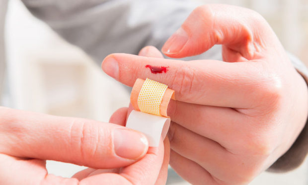 bigstock-applying-adhesive-bandage-on-b-119566553